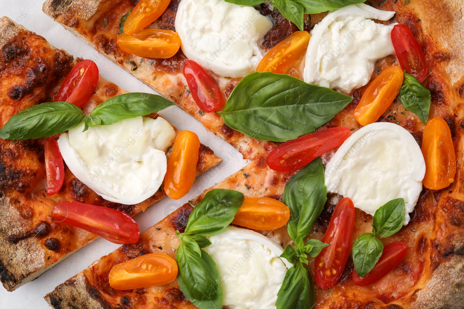 Photo of Delicious pizza with burrata cheese, tomatoes and basil on table, flat lay