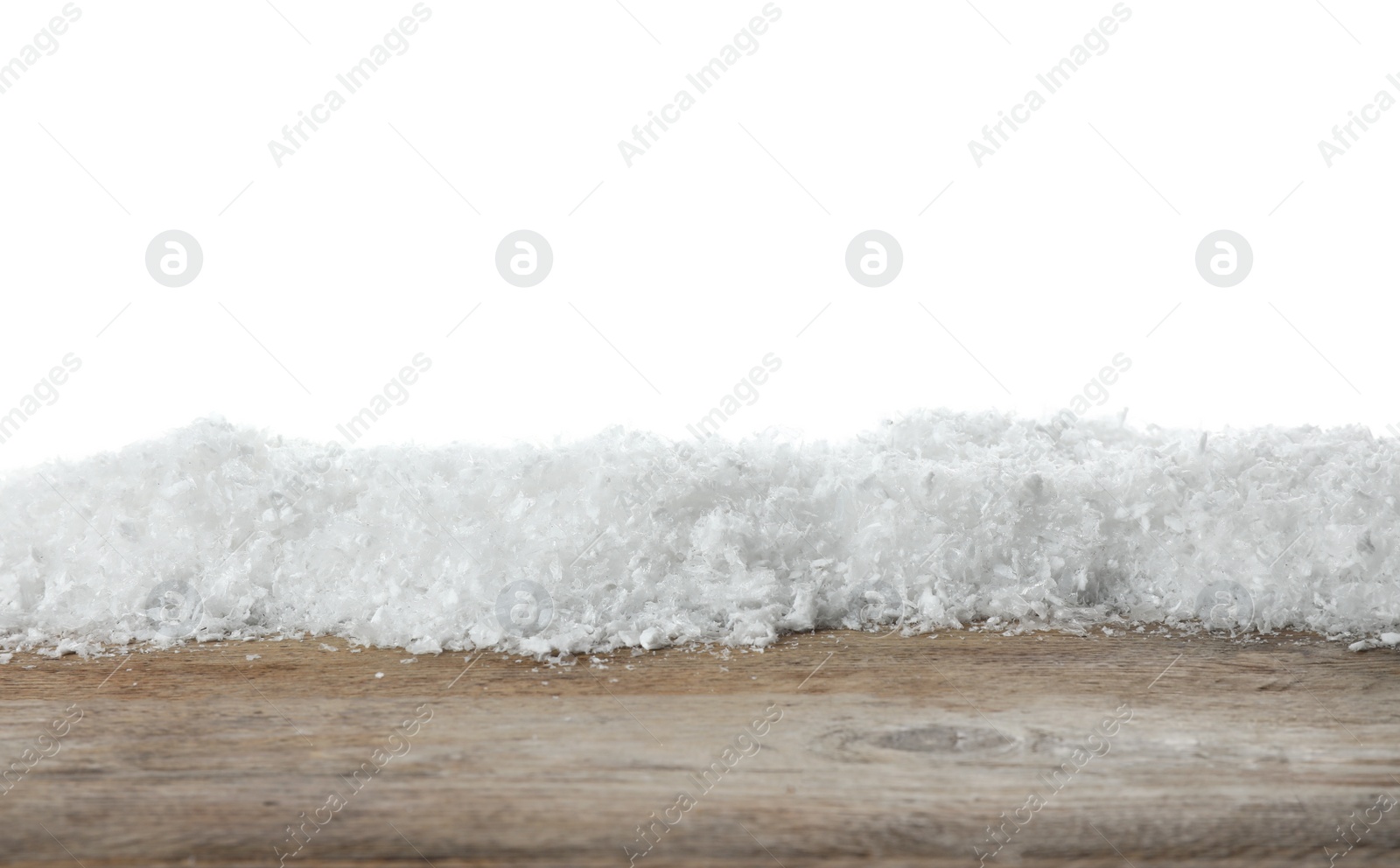 Photo of Heap of snow on wooden surface against white background. Christmas season