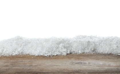 Photo of Heap of snow on wooden surface against white background. Christmas season
