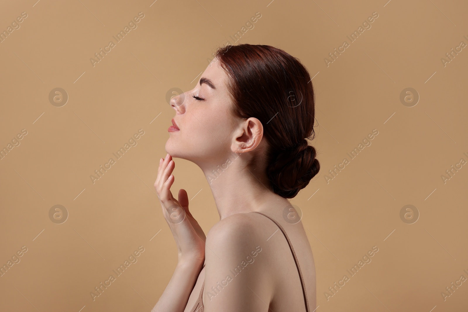 Photo of Portrait of beautiful woman on beige background. Space for text