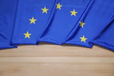 Flag of European Union on wooden table, top view. Space for text