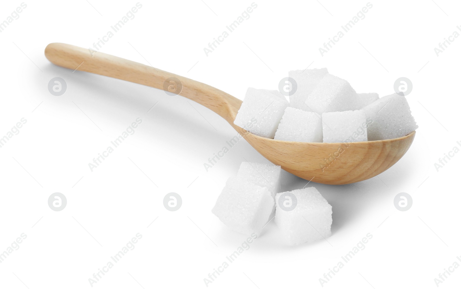 Photo of Many sugar cubes and wooden spoon isolated on white