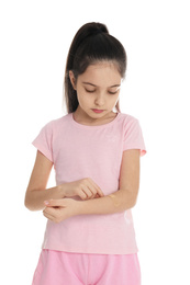 Photo of Girl putting sticking plaster onto arm on white background