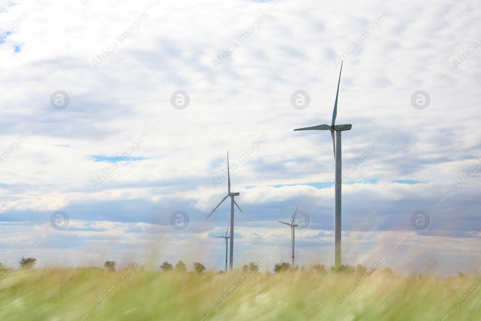 Photo of Beautiful view of field with wind turbines. Alternative energy source