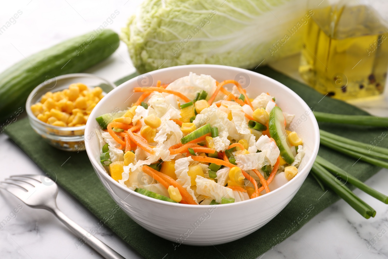 Photo of Tasty salad with Chinese cabbage served on white marble table