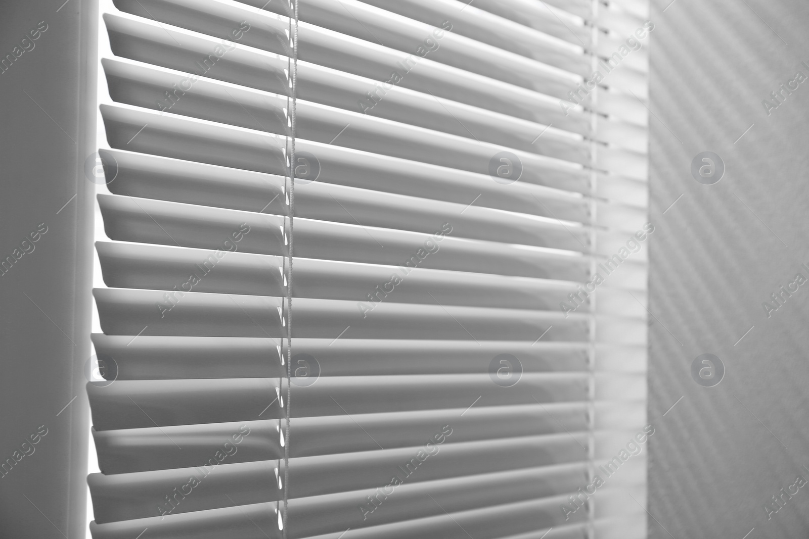 Photo of Closeup view of window with closed horizontal blinds