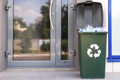 Many used plastic bottles in trash bin outdoors. Recycling problem