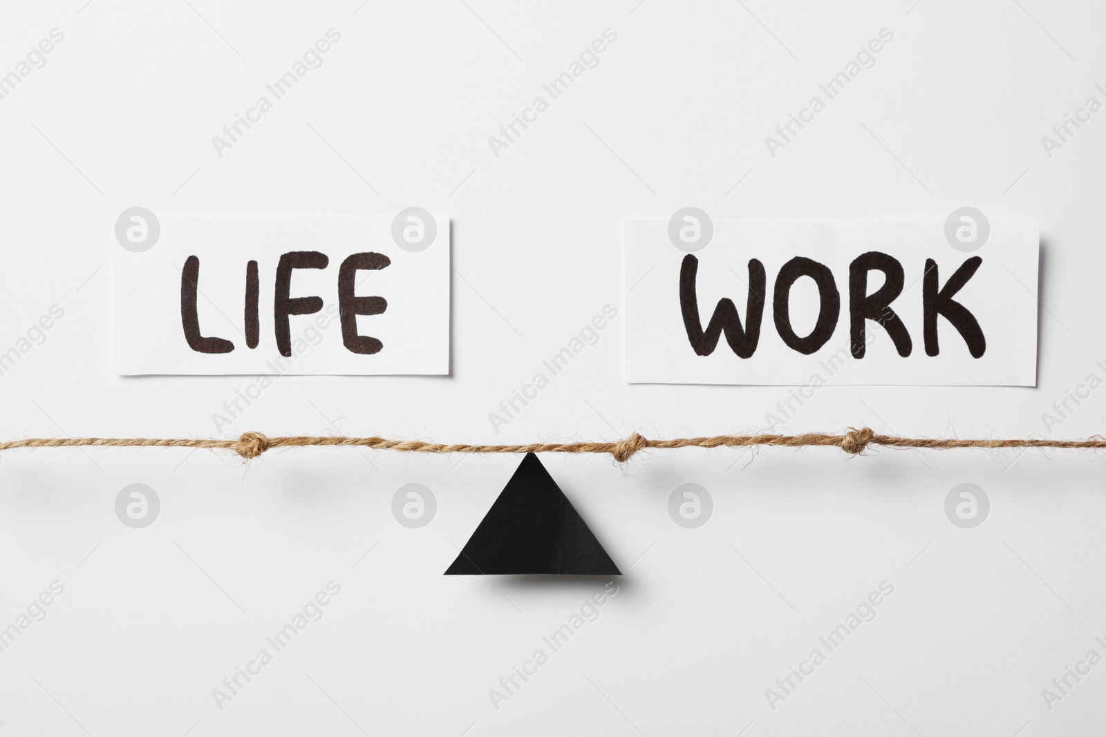 Photo of Black triangle, rope and words Life, Work on white background, flat lay. Balance concept