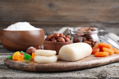 Marzipan and other ingredients for homemade Stollen on wooden table. Baking traditional German Christmas bread