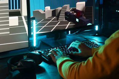 Photo of Man playing video games on computer indoors, closeup