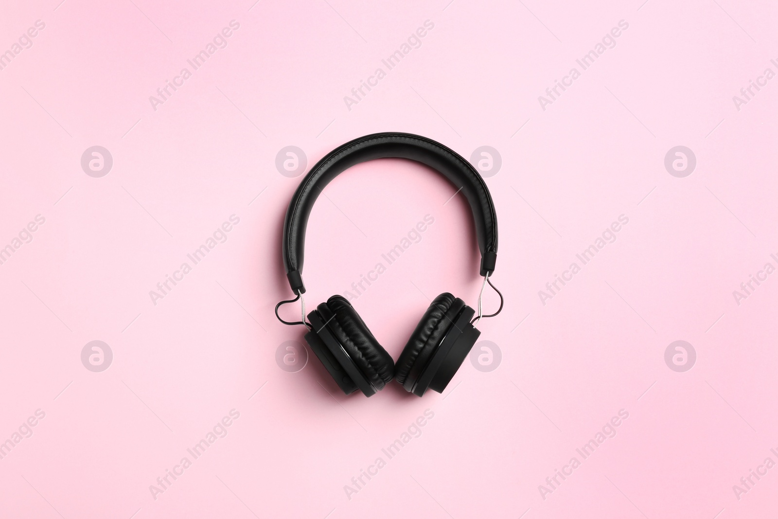 Photo of Stylish headphones on color background, top view