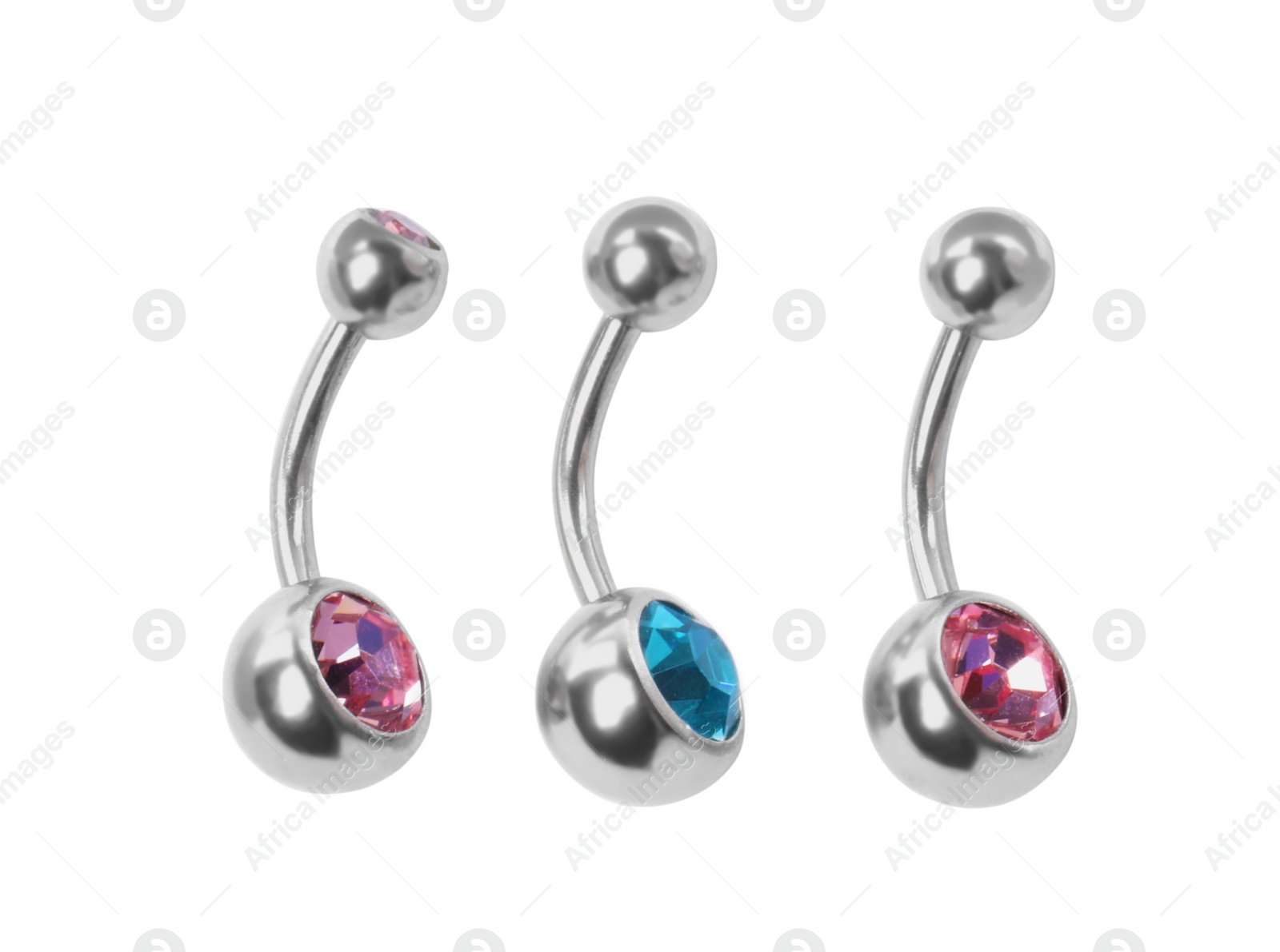 Photo of Piercing jewelry. Different belly button rings on white background, top view