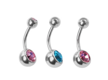 Photo of Piercing jewelry. Different belly button rings on white background, top view