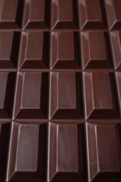 Delicious dark chocolate bar as background, closeup