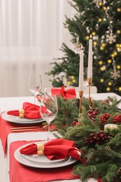 Beautiful table setting with Christmas decor indoors