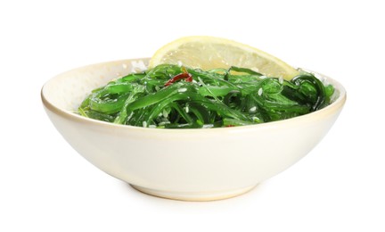 Japanese seaweed salad with lemon slice in bowl isolated on white
