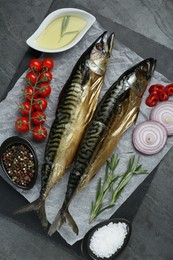 Photo of Delicious smoked mackerels and products on gray table, top view