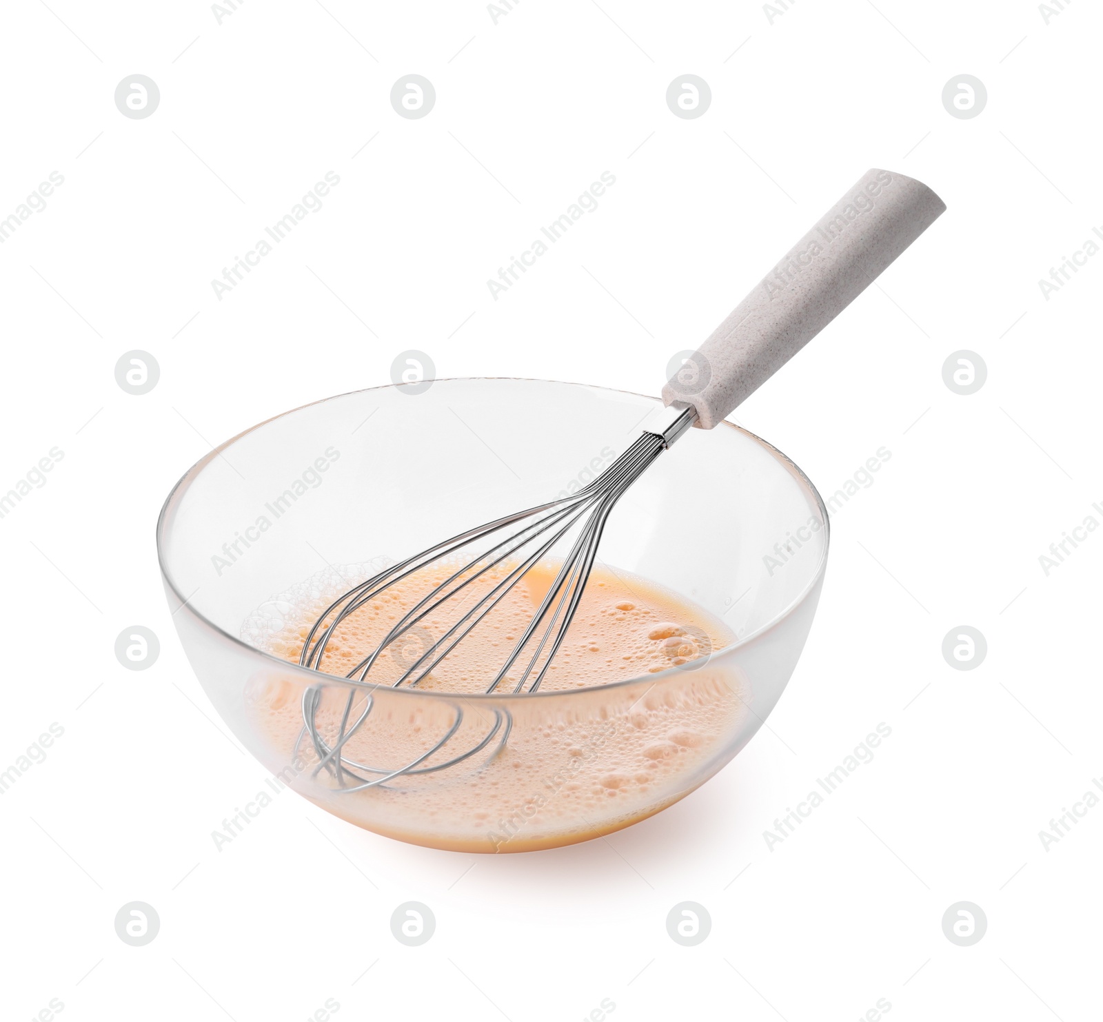 Photo of Beaten eggs and whisk in glass bowl isolated on white
