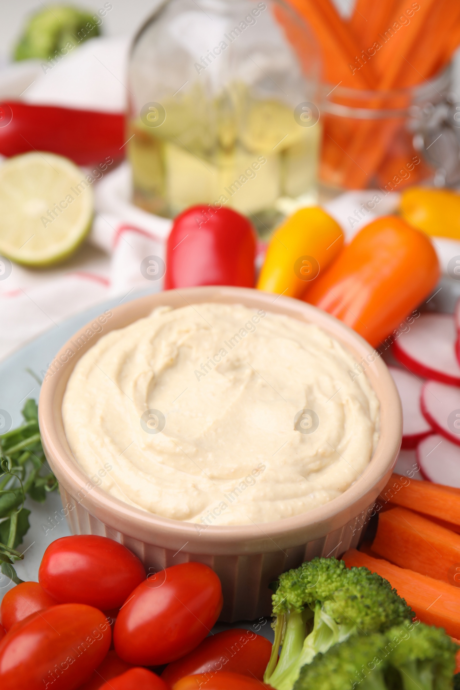 Photo of Plate with delicious hummus and fresh vegetables, closeup