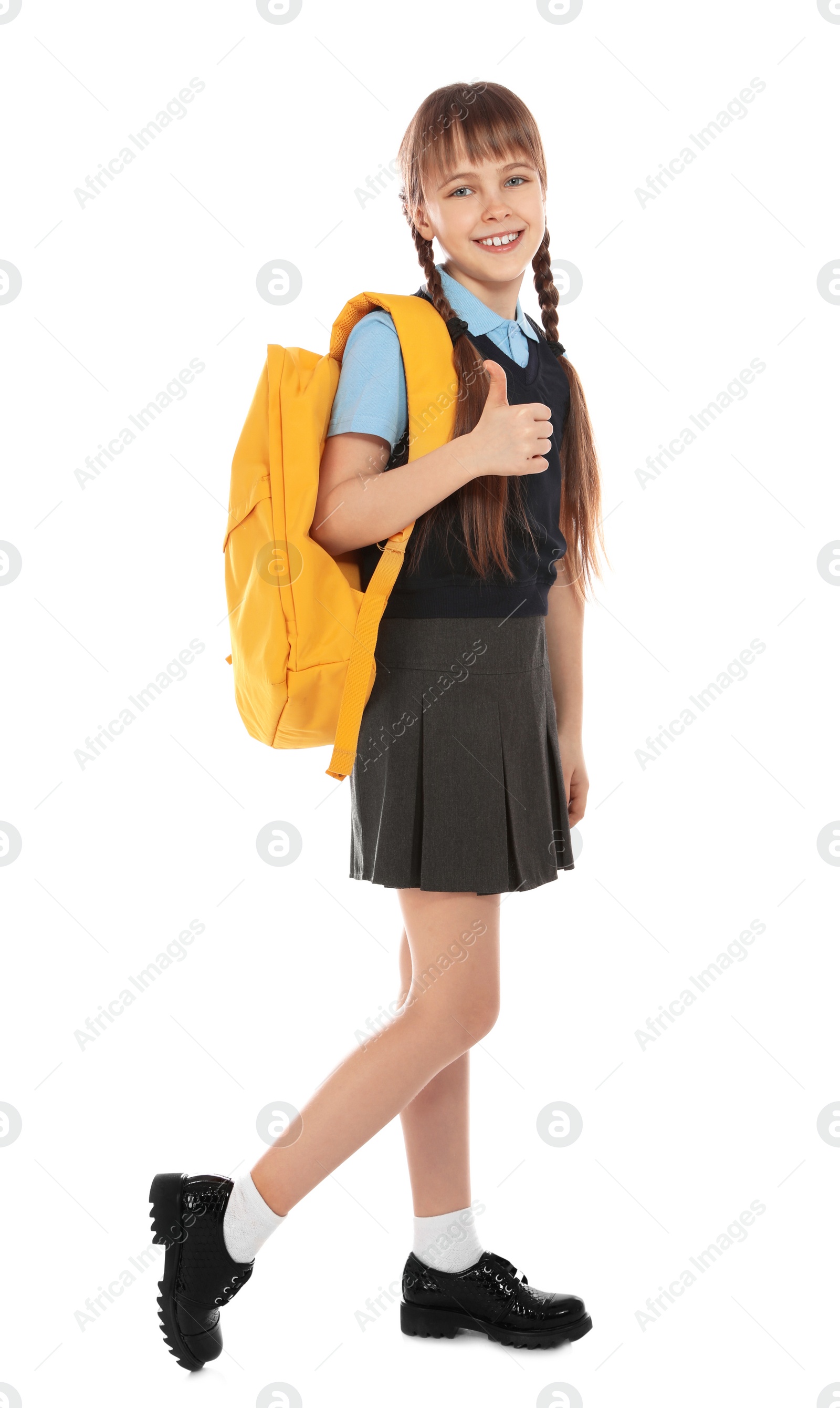 Photo of Full length portrait of cute girl in school uniform with backpack on white background