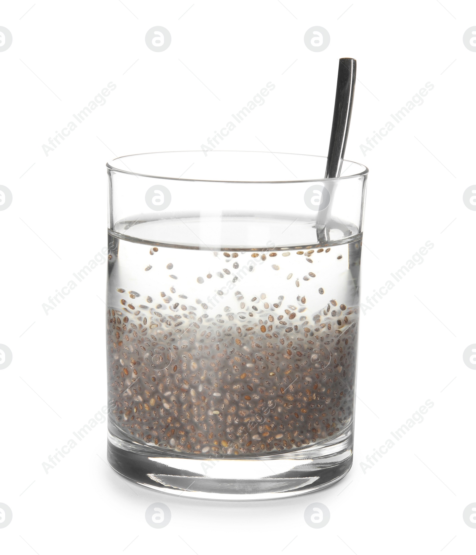 Photo of Glass of water with chia seeds and spoon on white background