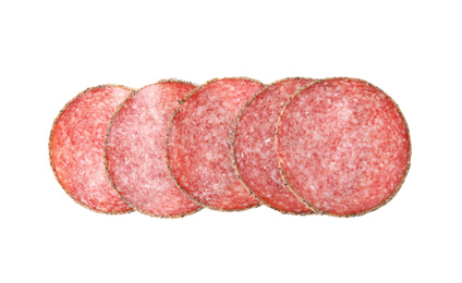 Slices of tasty sausage on white background, top view