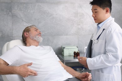 Photo of Senior patient having appointment with doctor in clinic