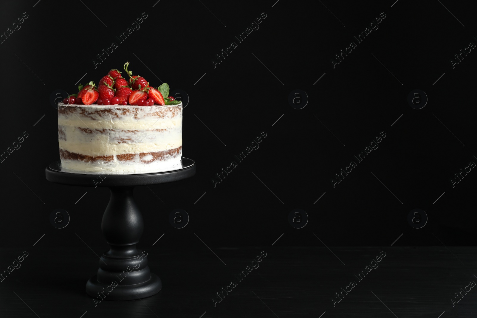 Photo of Delicious homemade cake with fresh berries and space for text on black background