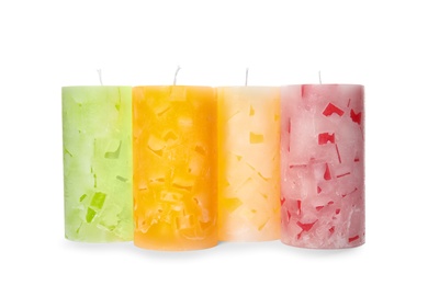 Photo of Four color wax candles on white background