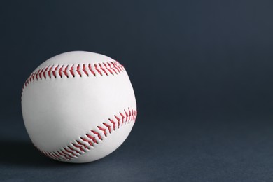 Baseball ball on dark background, closeup with space for text. Sports game