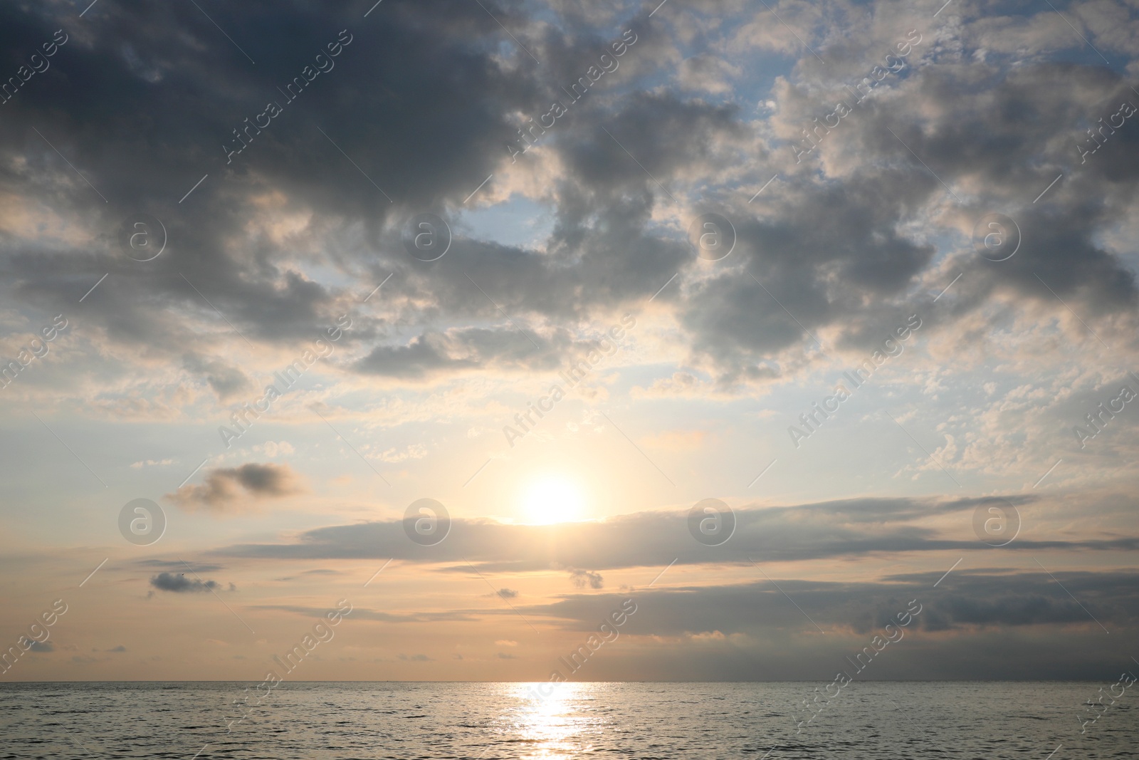 Photo of Picturesque view of sunset with beautiful clouds over sea