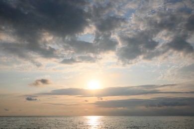 Picturesque view of sunset with beautiful clouds over sea