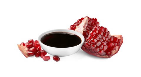 Photo of Bowl of pomegranate sauce and fresh ripe fruit on white background