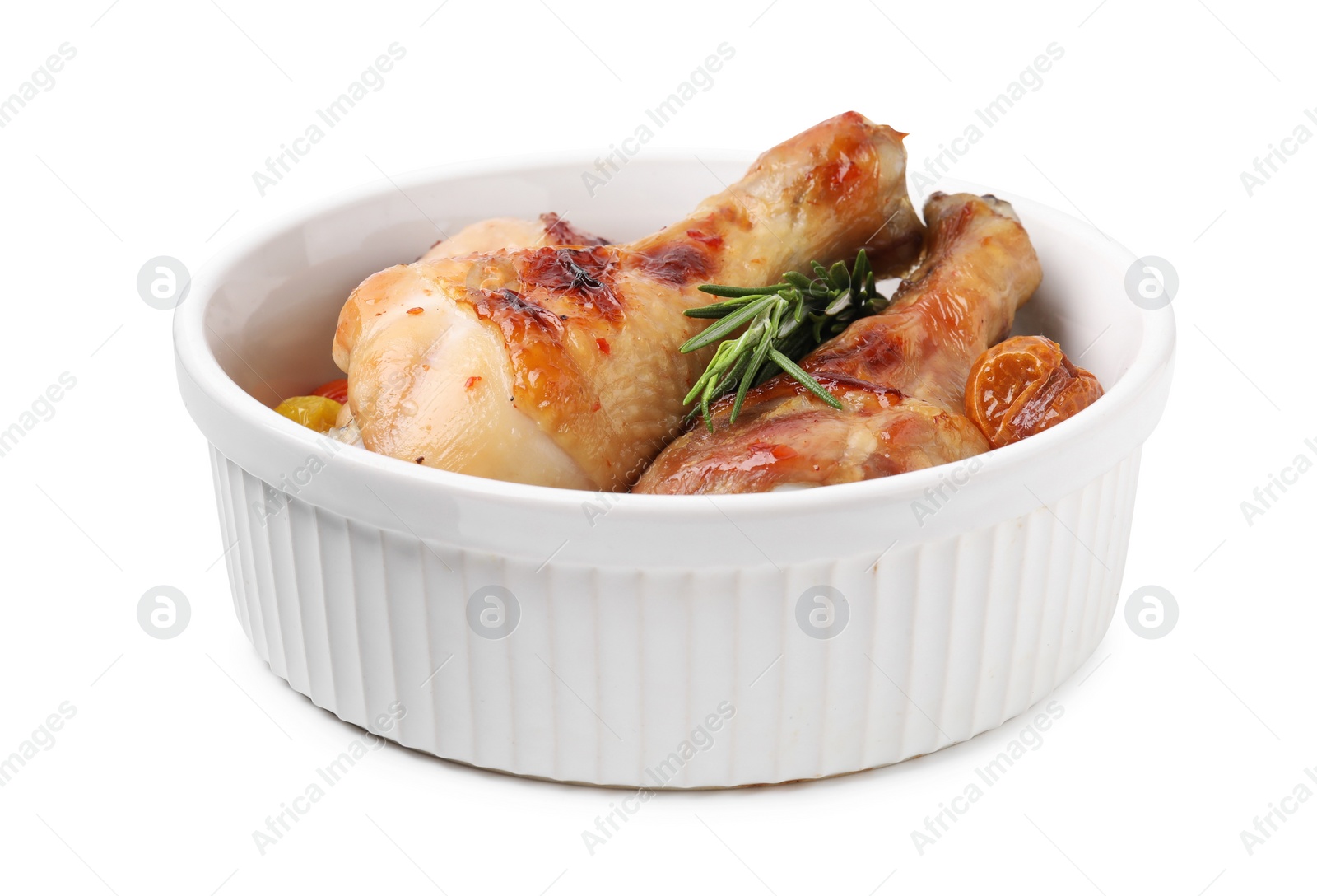 Photo of Delicious roasted chicken drumsticks with rosemary and tomatoes in bowl isolated on white