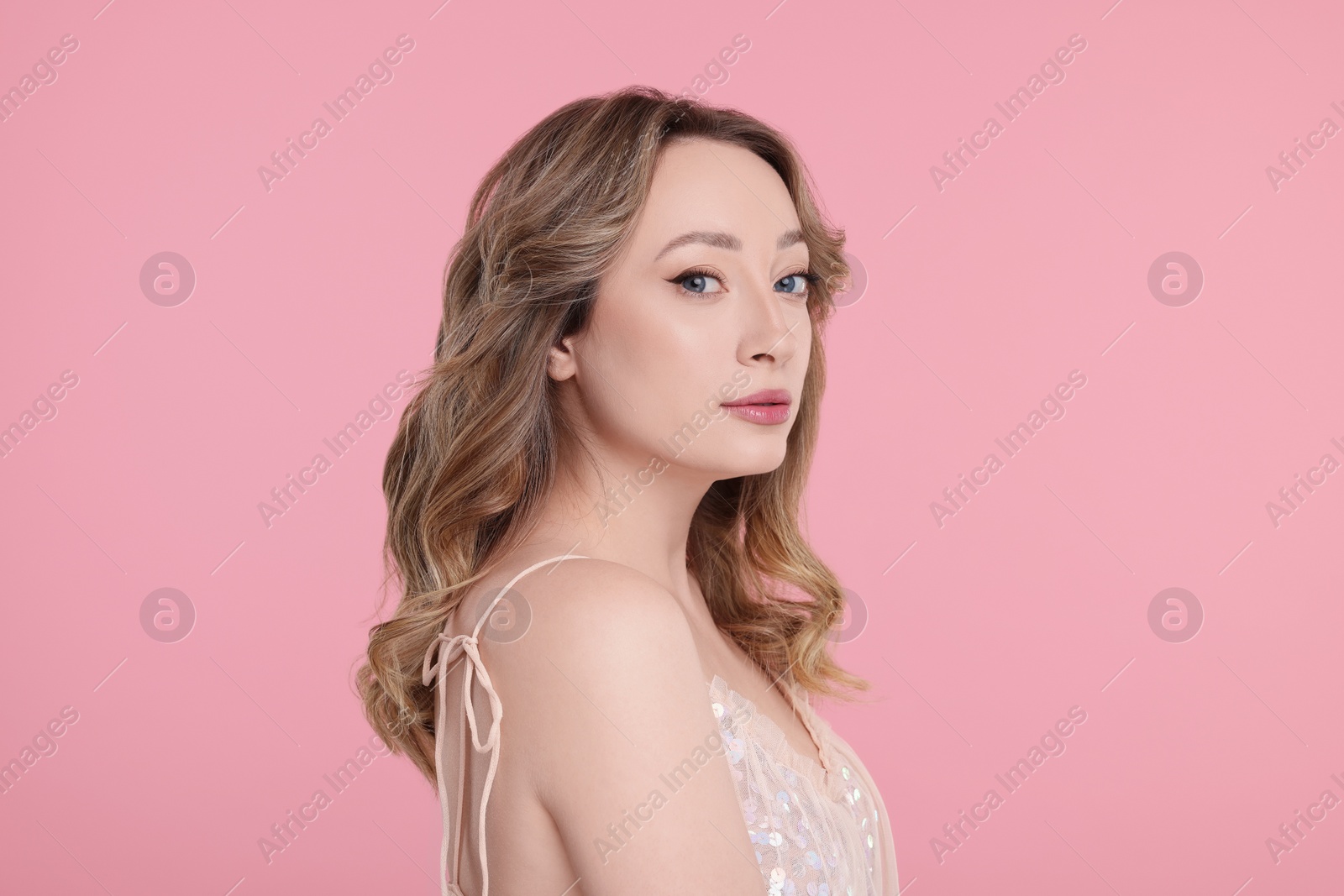 Photo of Portrait of beautiful woman on pink background