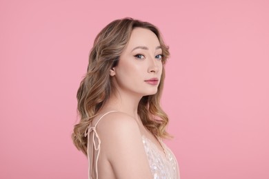 Portrait of beautiful woman on pink background