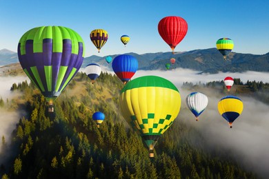 Bright hot air balloons flying over misty forest