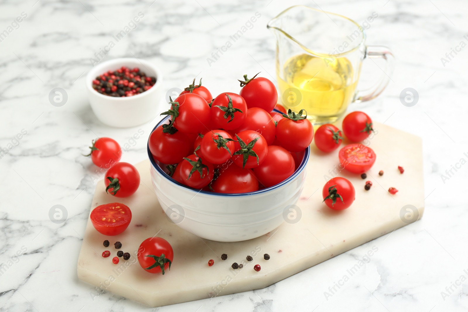 Photo of Fresh cherry tomatoes on white marble table