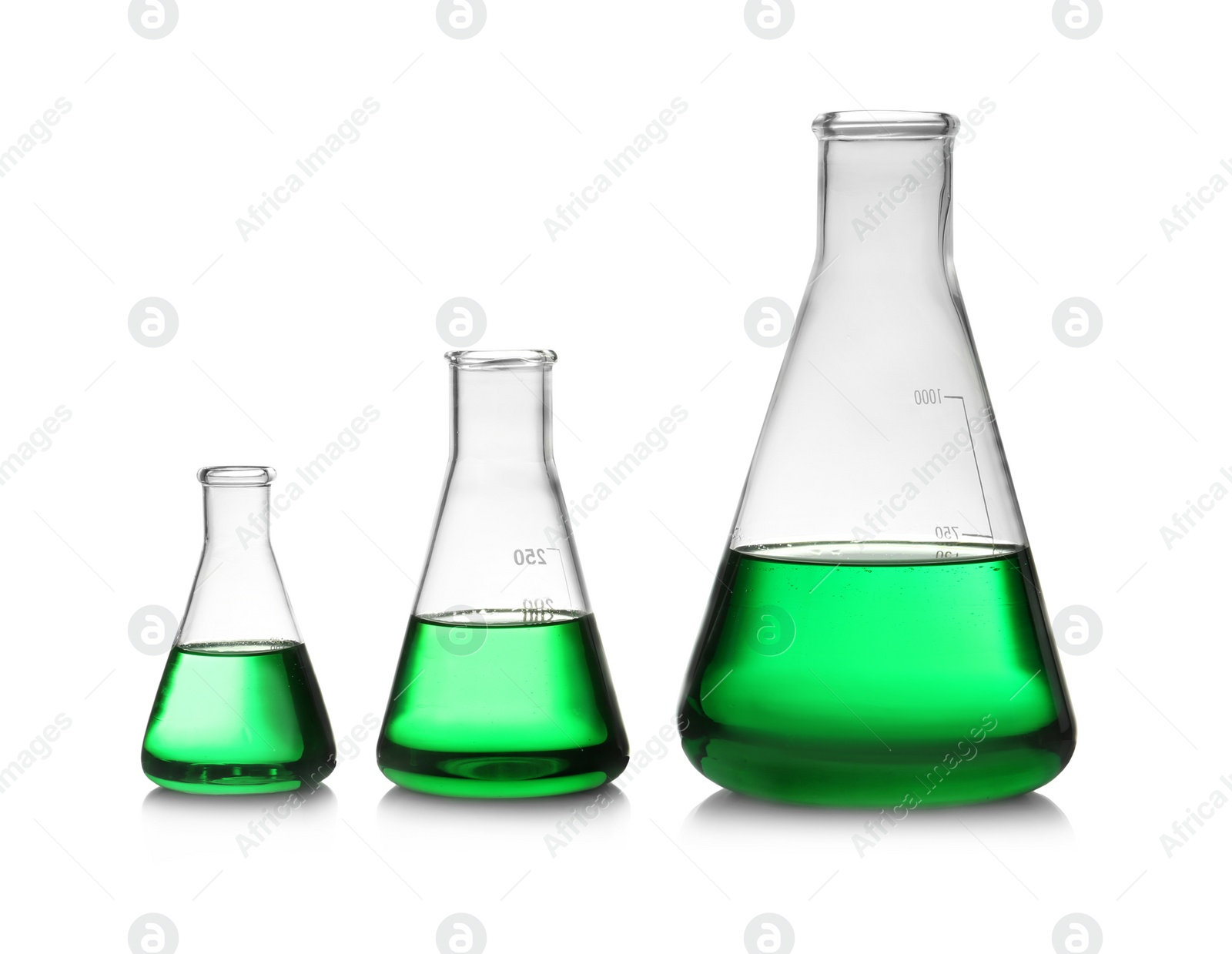 Photo of Conical flasks with green liquid on white background