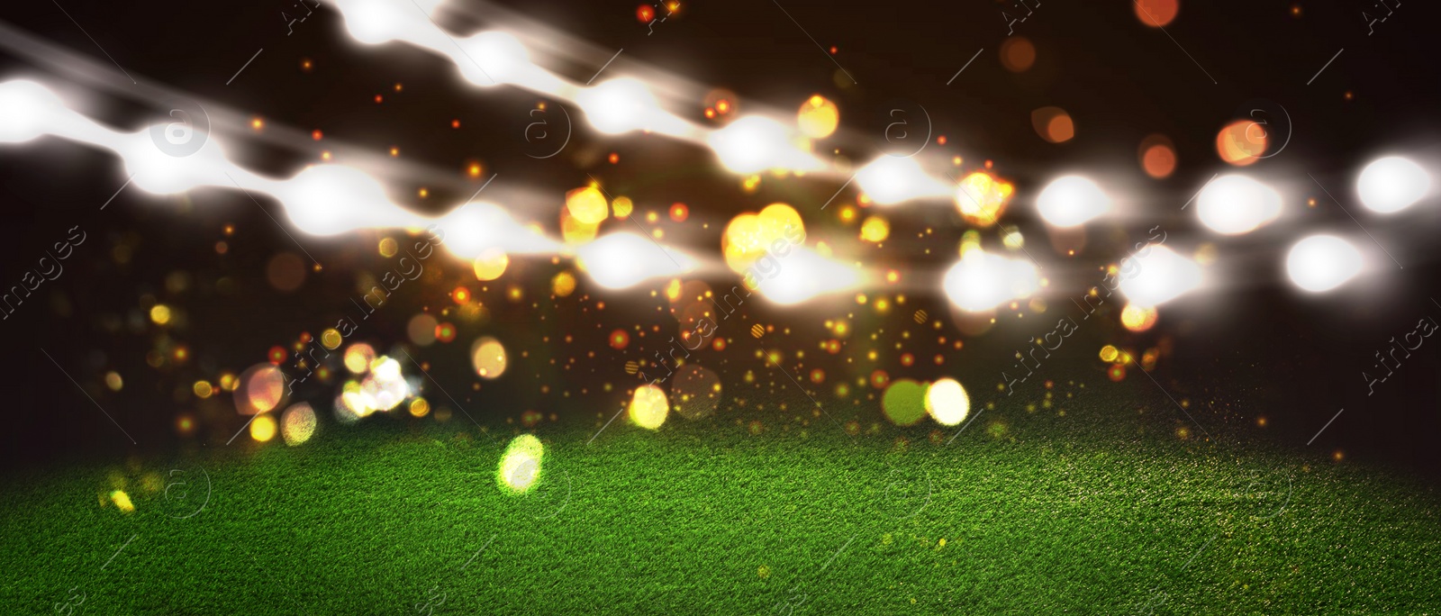 Image of Green sports field under stadium lights, bokeh effect. Banner design