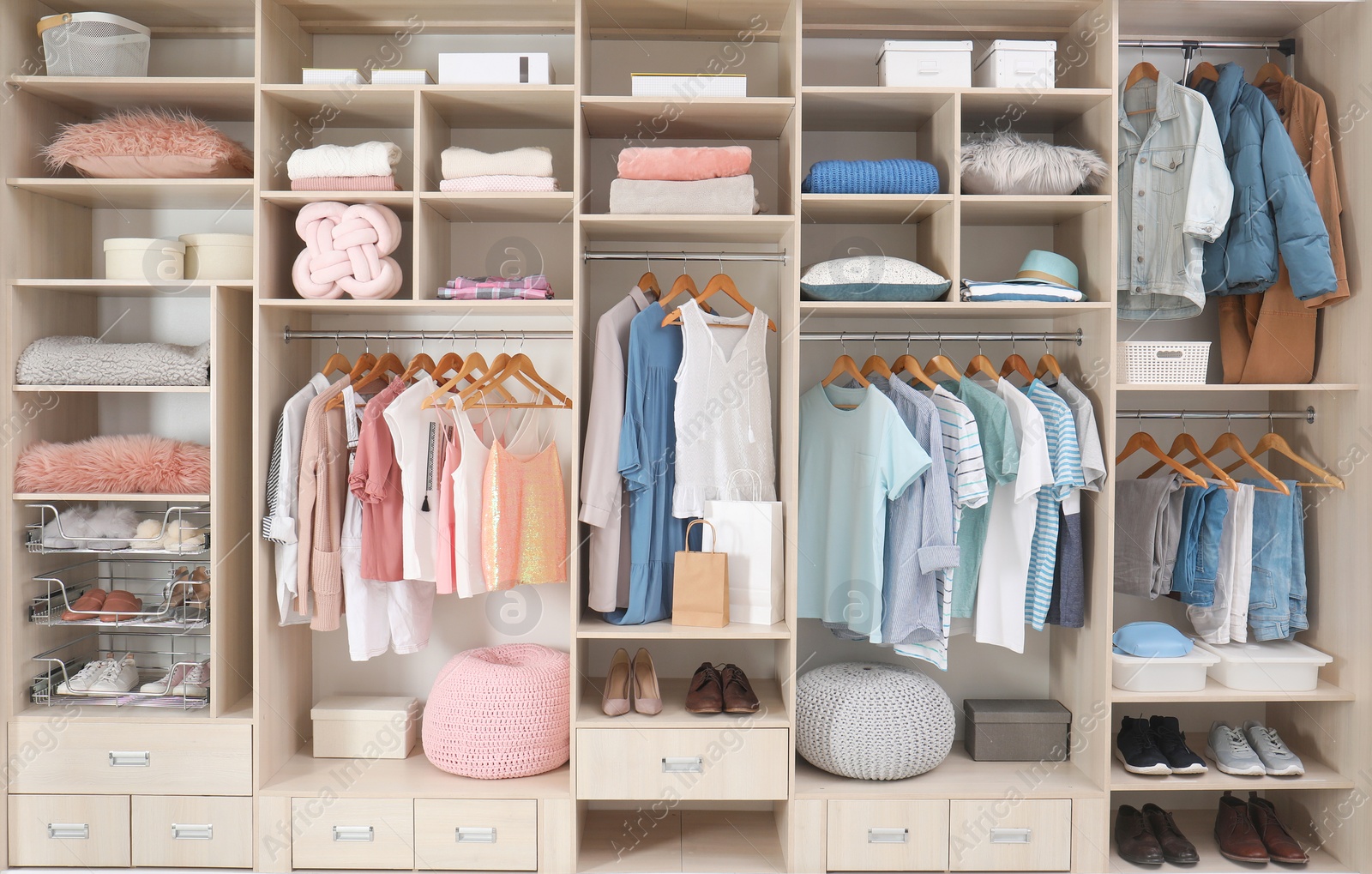 Photo of Stylish clothes, shoes and accessories in large wardrobe closet