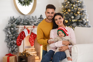 Photo of Happy family with cute baby at home. Christmas celebration