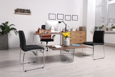 Photo of Stylish director's workplace with comfortable furniture and waiting area in office. Interior design