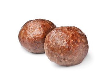 Photo of Two tasty cooked meatballs on white background
