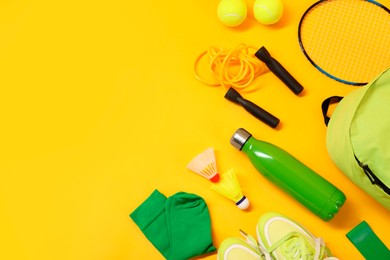 Photo of Different sports equipment on yellow background, flat lay. Space for text