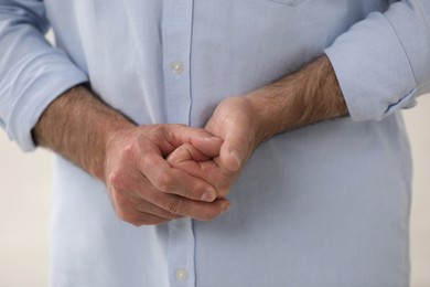 Photo of Man cracking his knuckles, closeup. Bad habit