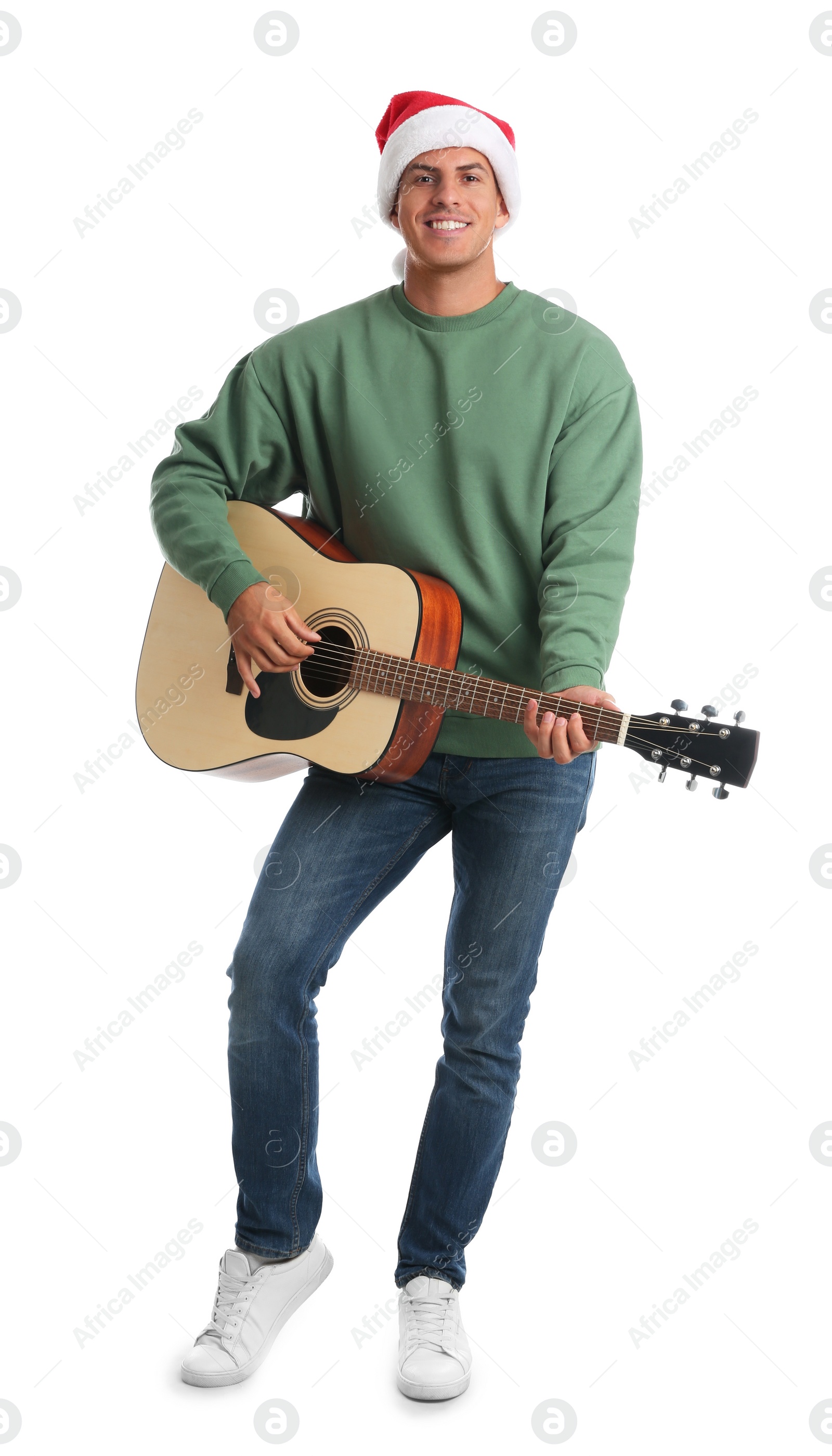 Photo of Man in Santa hat playing acoustic guitar on white background. Christmas music