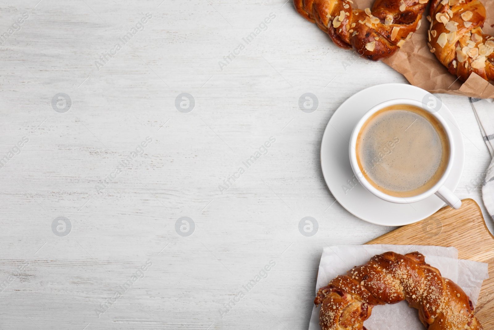 Photo of Delicious coffee and pastries on white wooden table, flat lay. Space for text