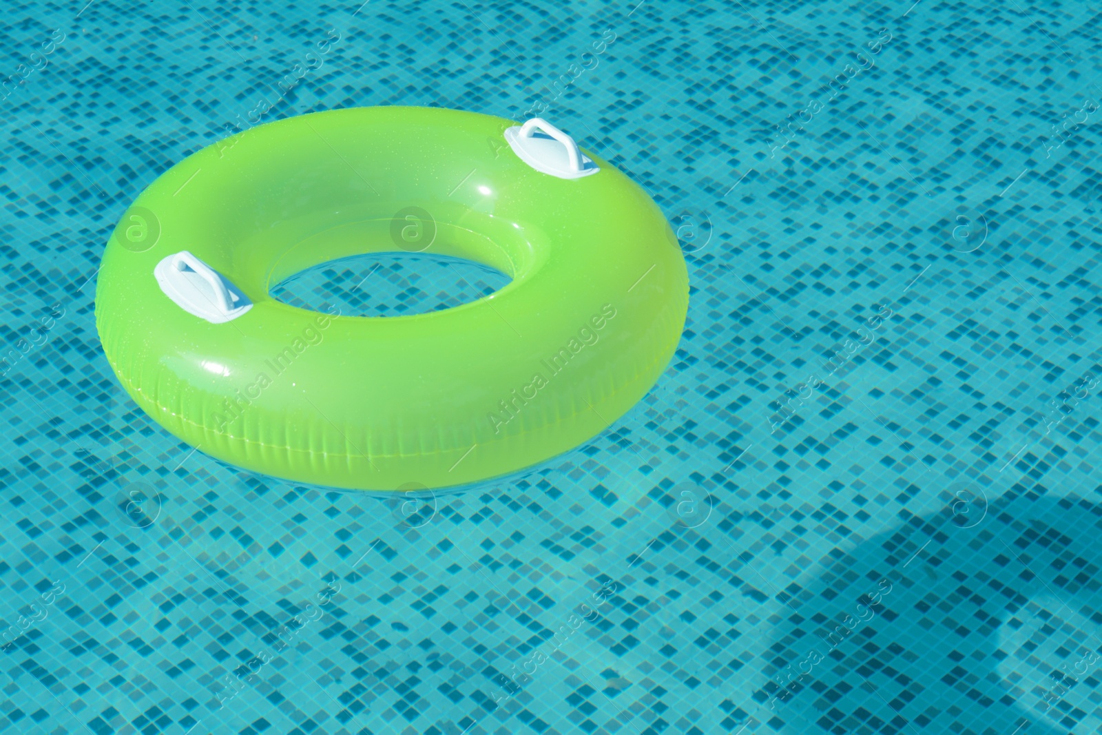 Photo of Light green inflatable ring floating in swimming pool. space for text