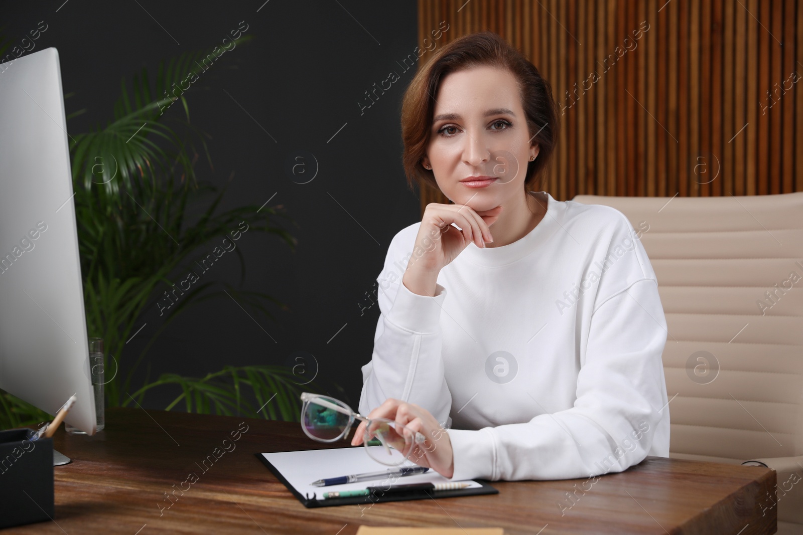 Photo of Portrait of psychotherapist at table in office